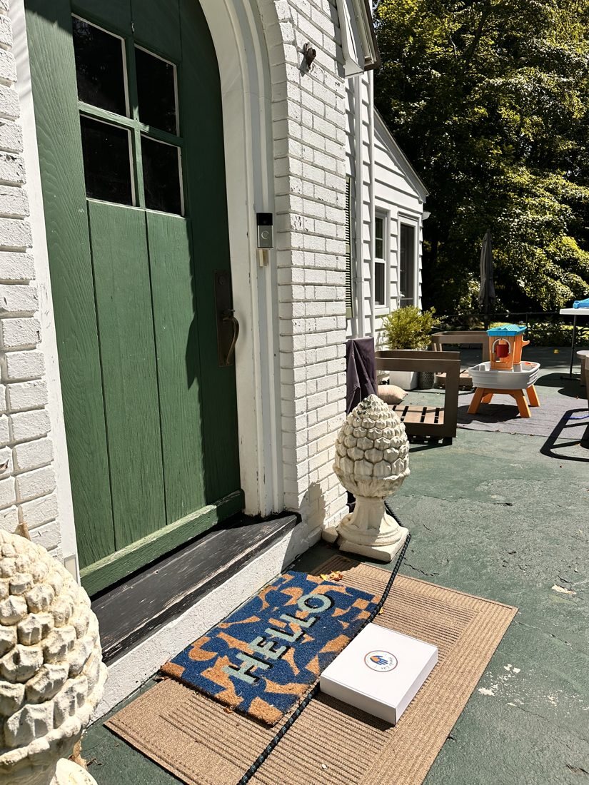A box waiting on a doormat